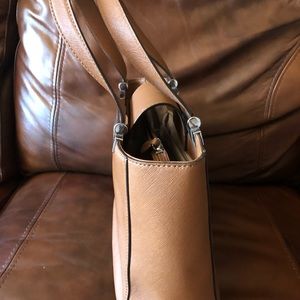 Michael Kors tan handbag with silver trimming.